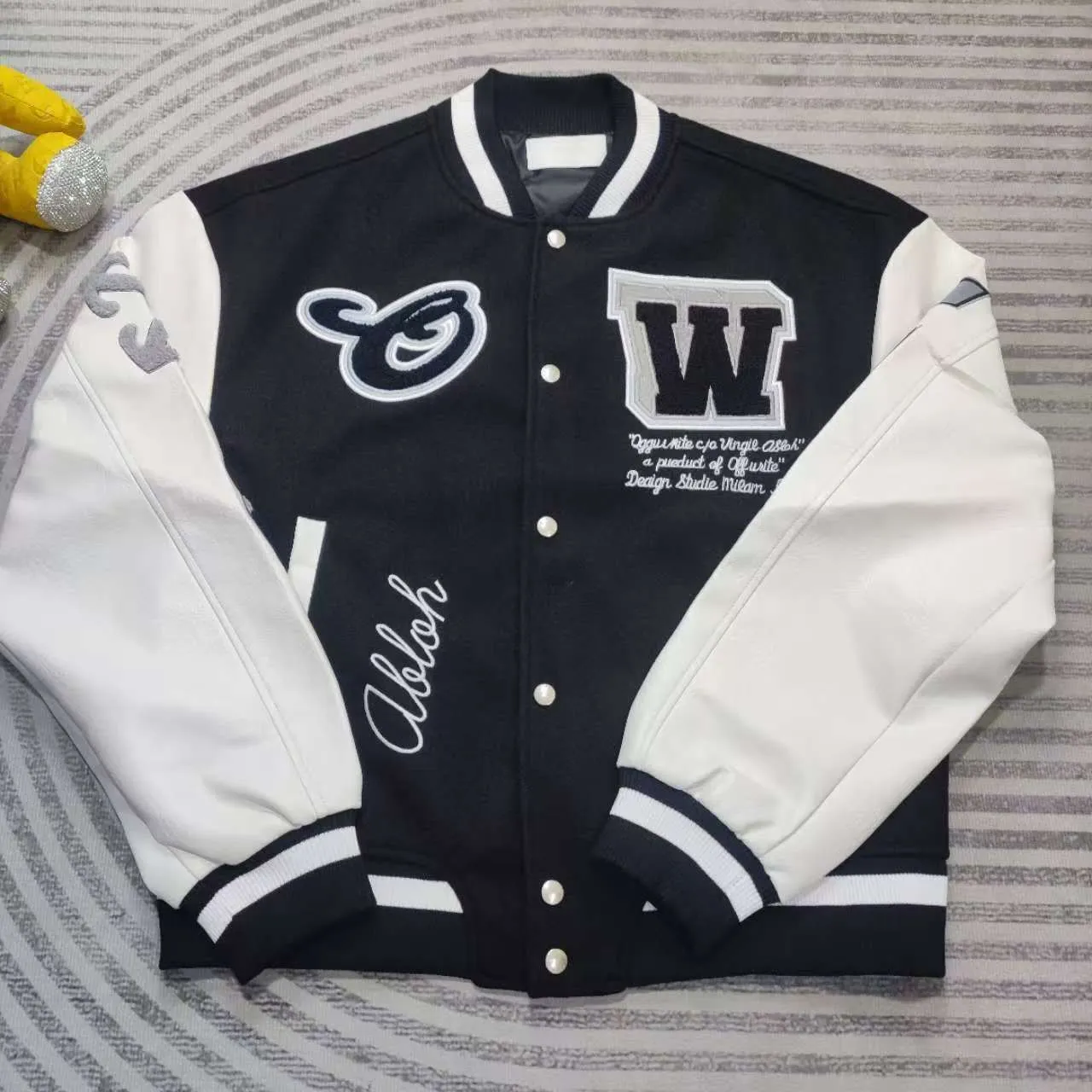 Top tested version off white heavy industry embroidery patchwork leather high temperature hot crystal diamond baseball uniform male and female couple star same style (⚠ original button mold customization, patch embroidery color matching) original packaging original label 🔍 full set of accessories customized packaging elevators are purchased from the original factory all series of hardware mold customization one-to-one restoration of fabric color components The fabric is made of 65% wool, 15% natural silk, 10% spandex and 10% velvet, mixed and custom-woven. The total weight is more than 900 grams! And the most important thing is its color fastness, it will never fade! -The embroidery uses an imported towel embroidery machine. Each pattern is first embroidered on the fabric, and then engraved with an infrared laser, and then fixed with a sewing machine. The whole garment is labeled in many places, one is flat embroidered, and the large pattern on the back is directly embroidered on it. This dress has 4 different embroidery techniques⚠ -The sleeves are all made of two-layer pebbled fabric, which is processed, shaped, colored, washed, and the texture retains the original grain structure! Thick, plump and round! -The processing technology is extremely complex, the cutting pieces are neatly aligned, and the entire garment has precise wiring density. Gender-neutral style. Loose fit, self-conscious quality control, details determine success or failure. Color: Black Size: S M L XL P: 680